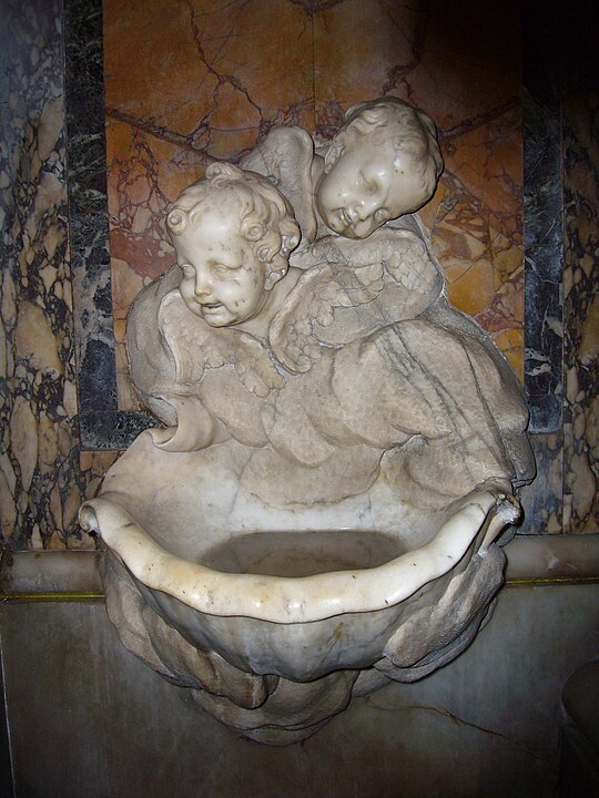 Holy water font (stoup) in Santa Maria Maddalena, Rome, Italy.